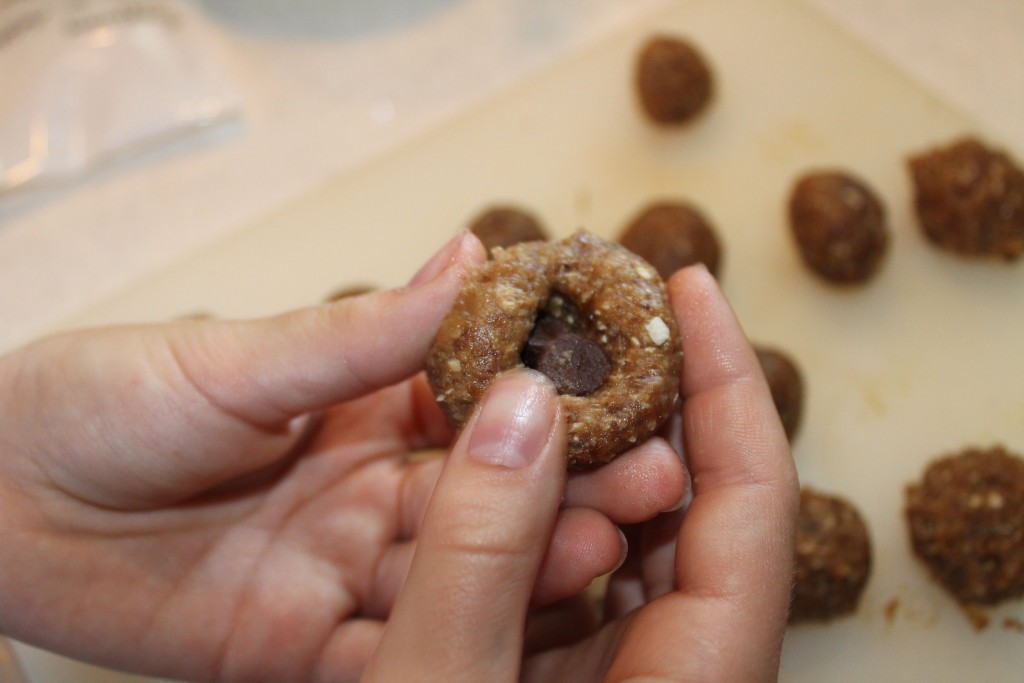 Putting chocolate chips in the date drops.